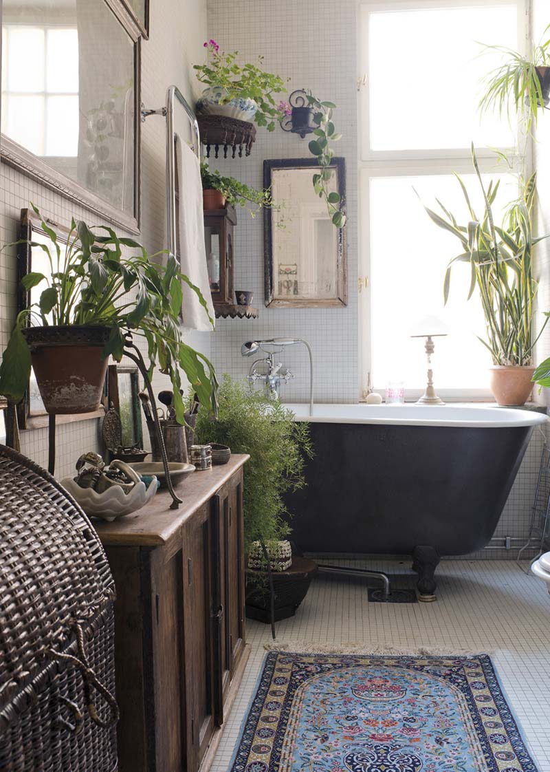 Bohemian badkamer met vintage badkuip en mooie planten