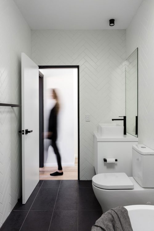 Moderne zwart wit badkamer met witte visgraat wandtegels