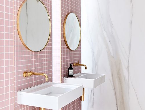 Roze badkamer met dubbele douche en dubbele wastafel